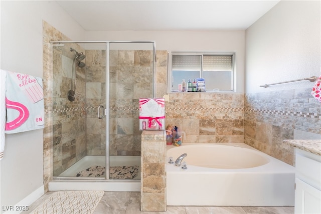 full bath featuring a garden tub, a shower stall, and vanity