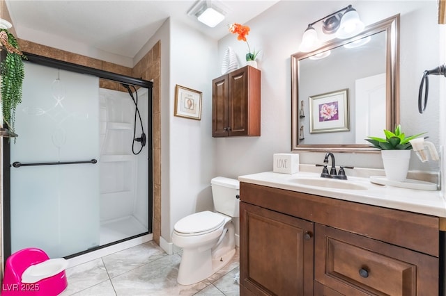 bathroom featuring toilet, a shower with door, and vanity