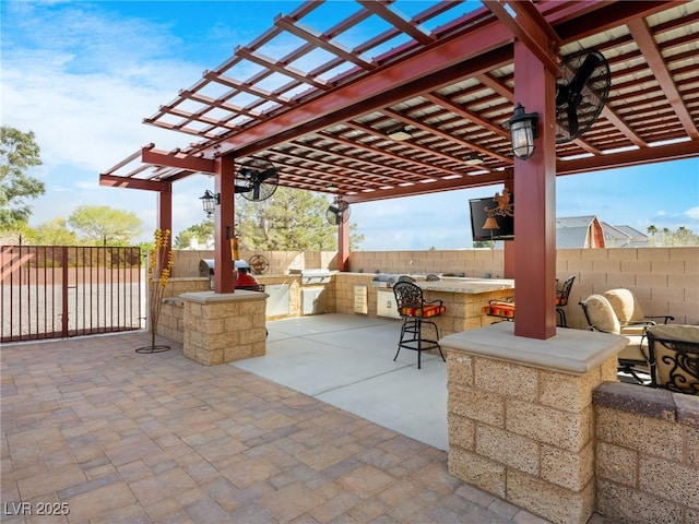 view of patio with area for grilling, a fenced backyard, outdoor dry bar, and a pergola