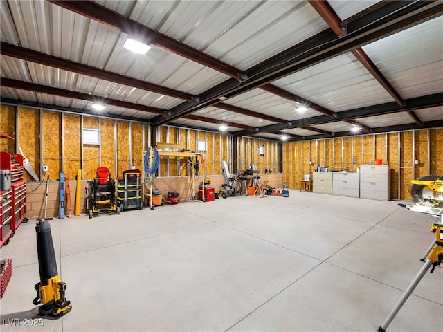 garage with a workshop area and metal wall