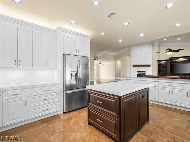 kitchen featuring visible vents, stainless steel fridge with ice dispenser, light countertops, dark brown cabinets, and white cabinetry