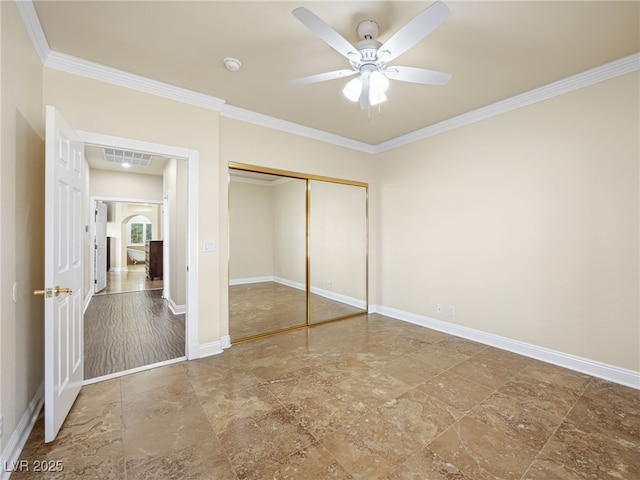 unfurnished bedroom with a ceiling fan, baseboards, visible vents, a closet, and crown molding