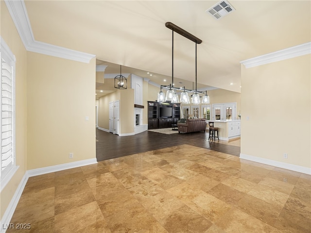 unfurnished living room with visible vents, a fireplace, crown molding, and baseboards