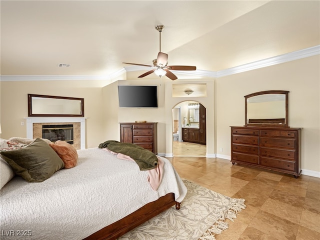 bedroom featuring visible vents, arched walkways, baseboards, and ornamental molding