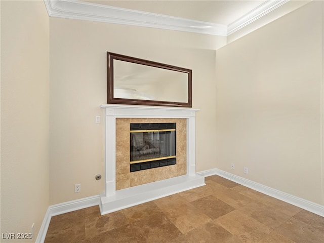 unfurnished living room with a premium fireplace, baseboards, and ornamental molding