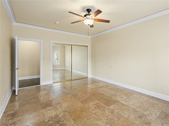 unfurnished bedroom featuring a ceiling fan, baseboards, ornamental molding, stone finish floor, and a closet