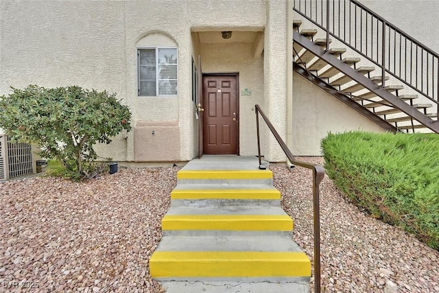 view of exterior entry with stucco siding