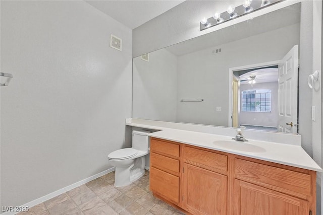 bathroom with visible vents, toilet, vanity, and baseboards