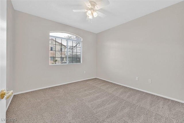 empty room with ceiling fan, baseboards, and carpet floors