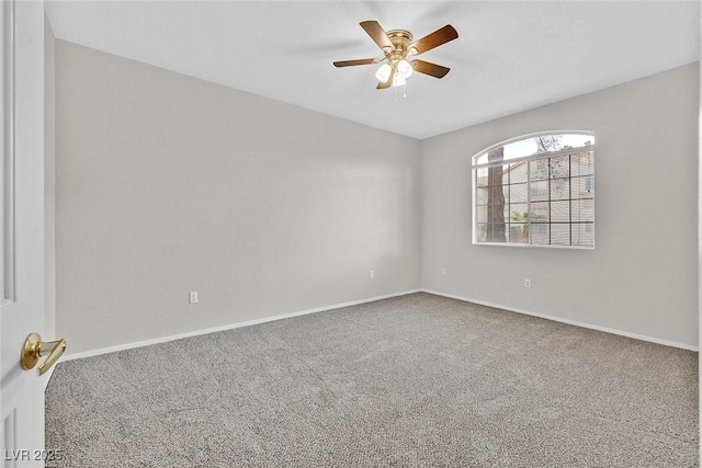 carpeted empty room featuring baseboards and ceiling fan