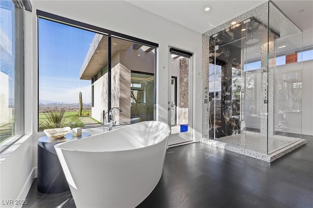 11 Cloud Chaser Blvd, Henderson, NV 89012 - full bathroom with a stall shower, a soaking tub, baseboards, and wood finished floors