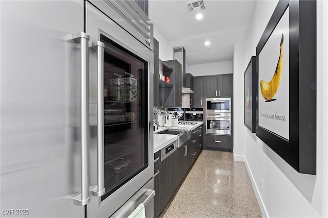 11 Cloud Chaser Blvd, Henderson, NV 89012 - kitchen with high end fridge, modern cabinets, visible vents, light speckled floor, and light countertops