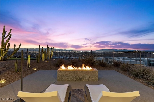 11 Cloud Chaser Blvd, Henderson, NV 89012 - patio terrace at dusk with an outdoor fire pit and fence