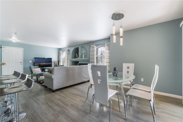 dining room with baseboards and wood finished floors