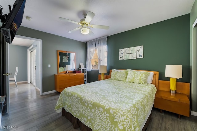 bedroom with wood finished floors, a ceiling fan, and baseboards