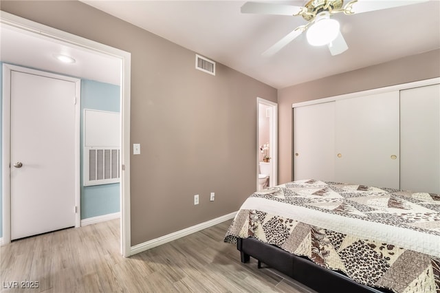 bedroom featuring a closet, visible vents, light wood-style flooring, and baseboards