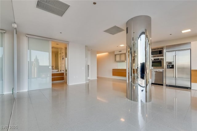 interior space with visible vents, baseboards, and built in appliances