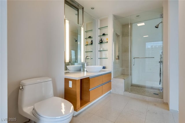 full bathroom featuring double vanity, a stall shower, toilet, tile patterned floors, and a sink