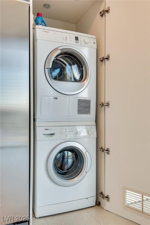 laundry area with laundry area and stacked washing maching and dryer