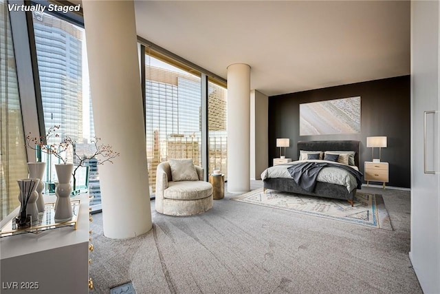 carpeted bedroom featuring expansive windows and multiple windows