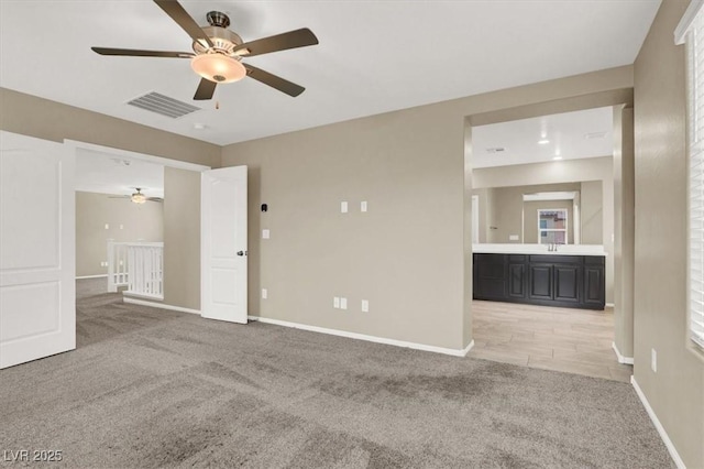 unfurnished room featuring light carpet, visible vents, and baseboards