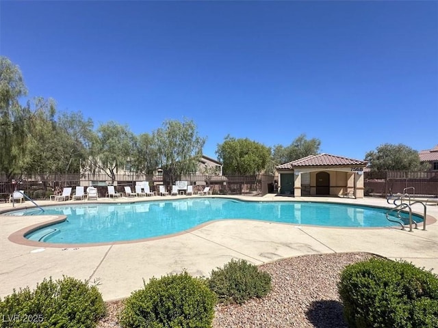 pool with a patio and fence