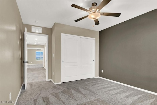 unfurnished bedroom with a closet, carpet, visible vents, and baseboards