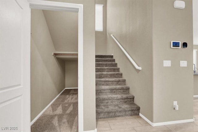 staircase featuring baseboards