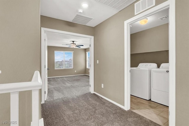 hall featuring washer and clothes dryer, carpet flooring, and visible vents