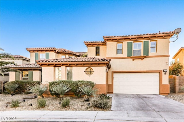 mediterranean / spanish-style house with a garage, driveway, and stucco siding