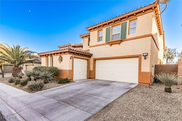 mediterranean / spanish-style house with a tile roof, stucco siding, concrete driveway, fence, and a garage