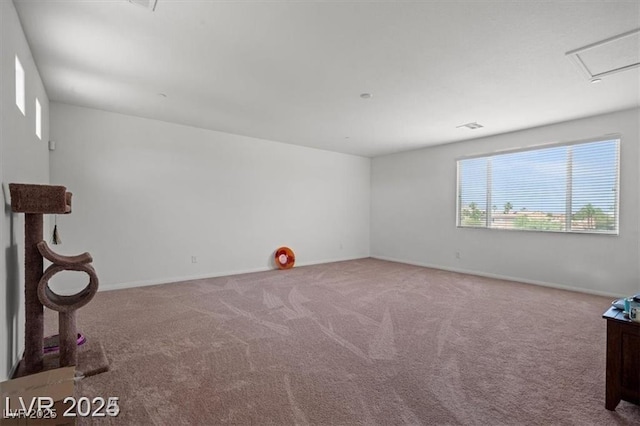 empty room featuring carpet and baseboards