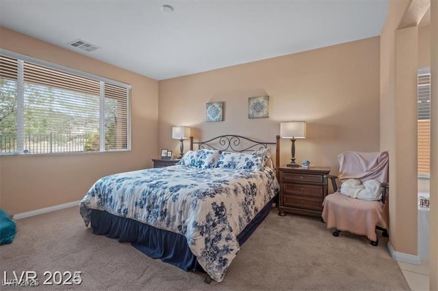 carpeted bedroom featuring visible vents and baseboards