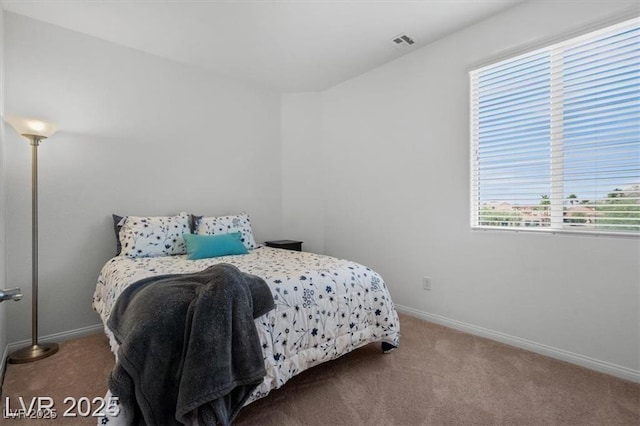 carpeted bedroom with visible vents and baseboards