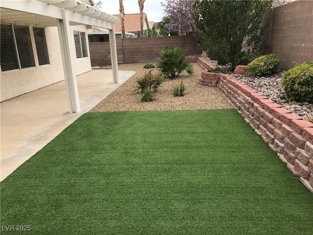 view of yard with a fenced backyard and a patio