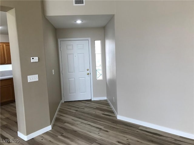 interior space with light wood-style flooring, visible vents, and baseboards