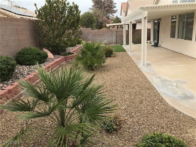 view of yard featuring a fenced backyard, a patio, and a pergola