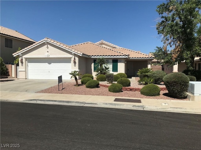 331 Mount Hope St, Henderson, NV 89014 - view of front of house featuring an attached garage, a tiled roof, stucco siding, and concrete driveway