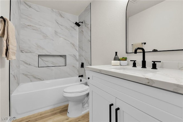 full bathroom with  shower combination, vanity, toilet, and wood finished floors