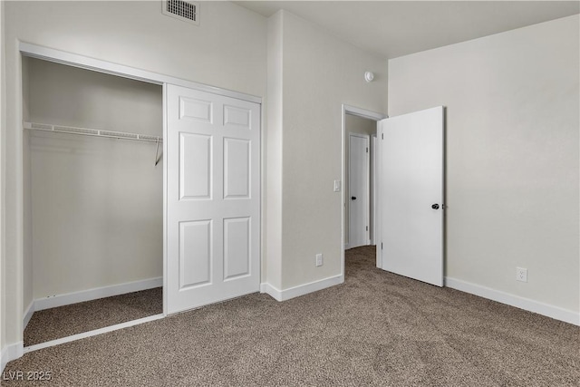 unfurnished bedroom featuring a closet, carpet, visible vents, and baseboards