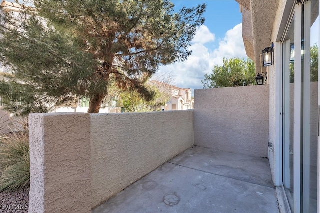 view of patio featuring a balcony