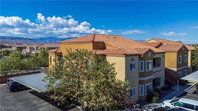 view of building exterior featuring a mountain view and a residential view