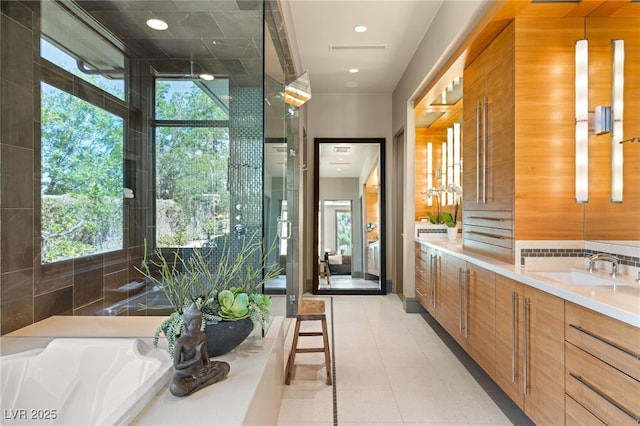 bathroom featuring recessed lighting, vanity, and a healthy amount of sunlight