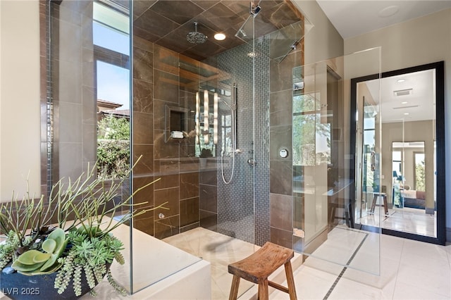 bathroom with a tile shower and tile patterned floors