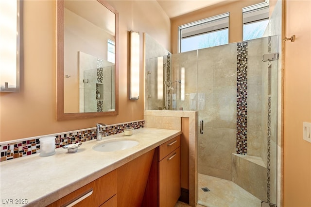 full bath with backsplash, a shower stall, and vanity