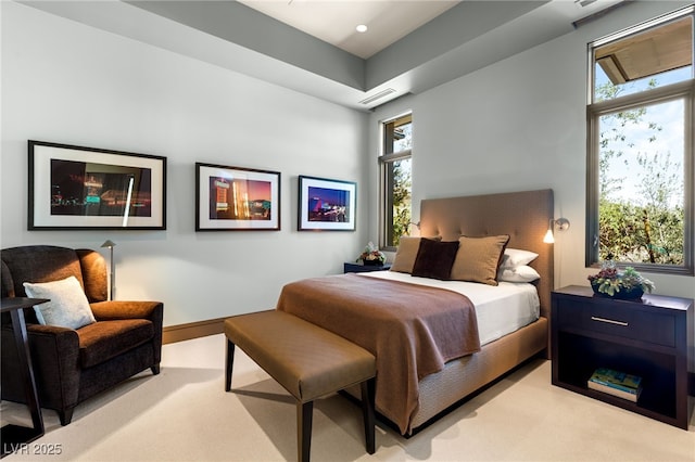 bedroom featuring light carpet and multiple windows