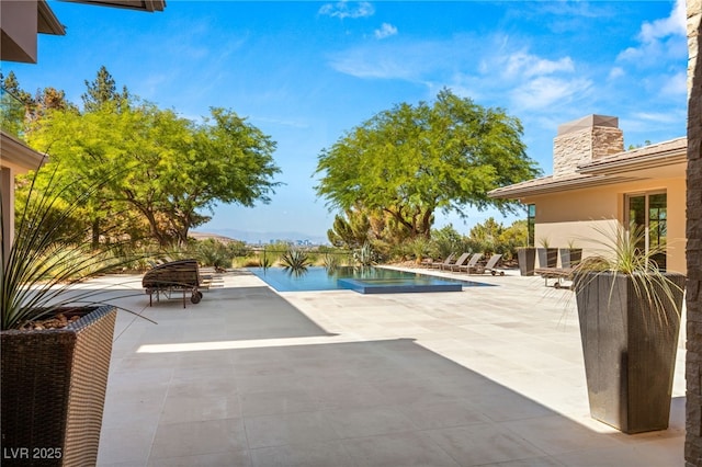 outdoor pool with a patio area