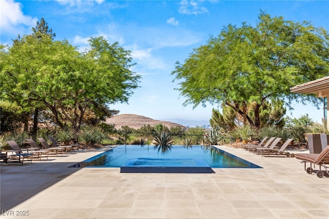 pool featuring a patio area and a mountain view