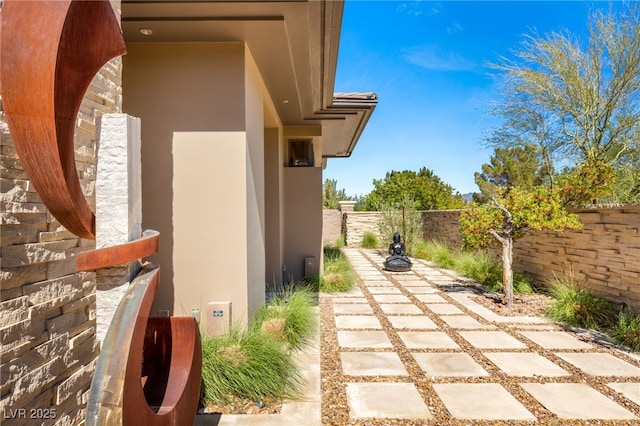 exterior space featuring a patio area, fence, a tiled roof, and stucco siding