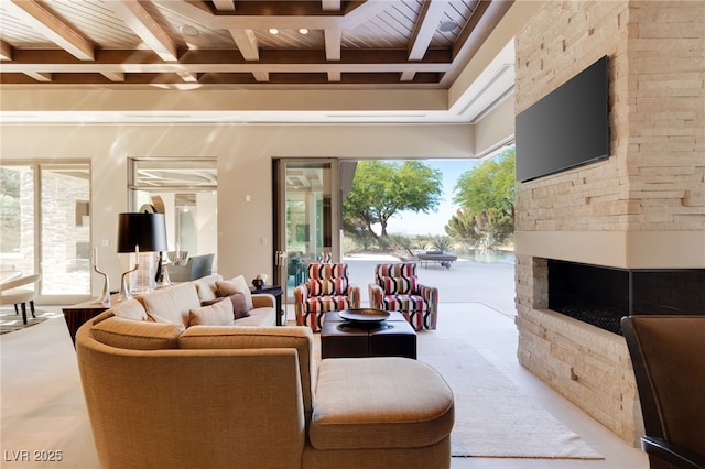 living area featuring wood ceiling, a fireplace, and beam ceiling